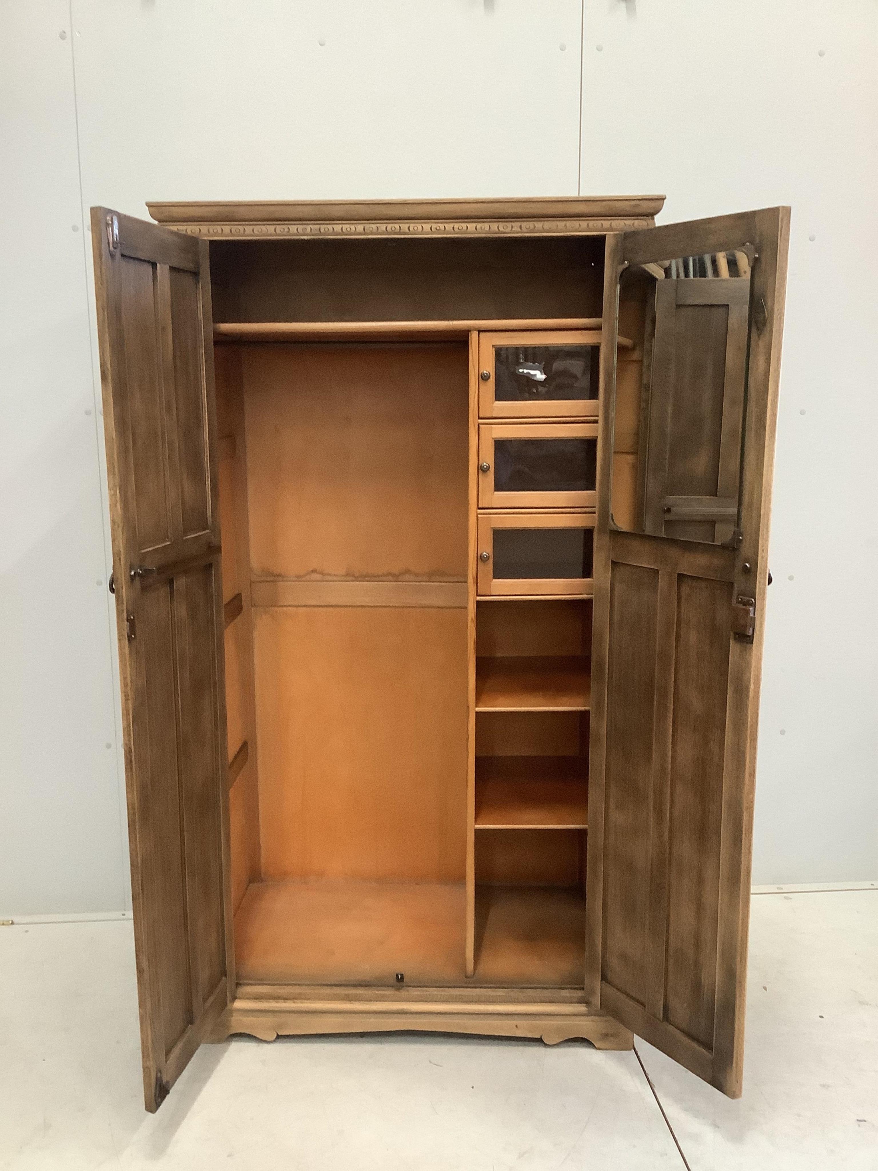 An early 20th century oak linenfold moulded oak compactum wardrobe, width 96cm, depth 53cm, height 174cm. Condition - fair